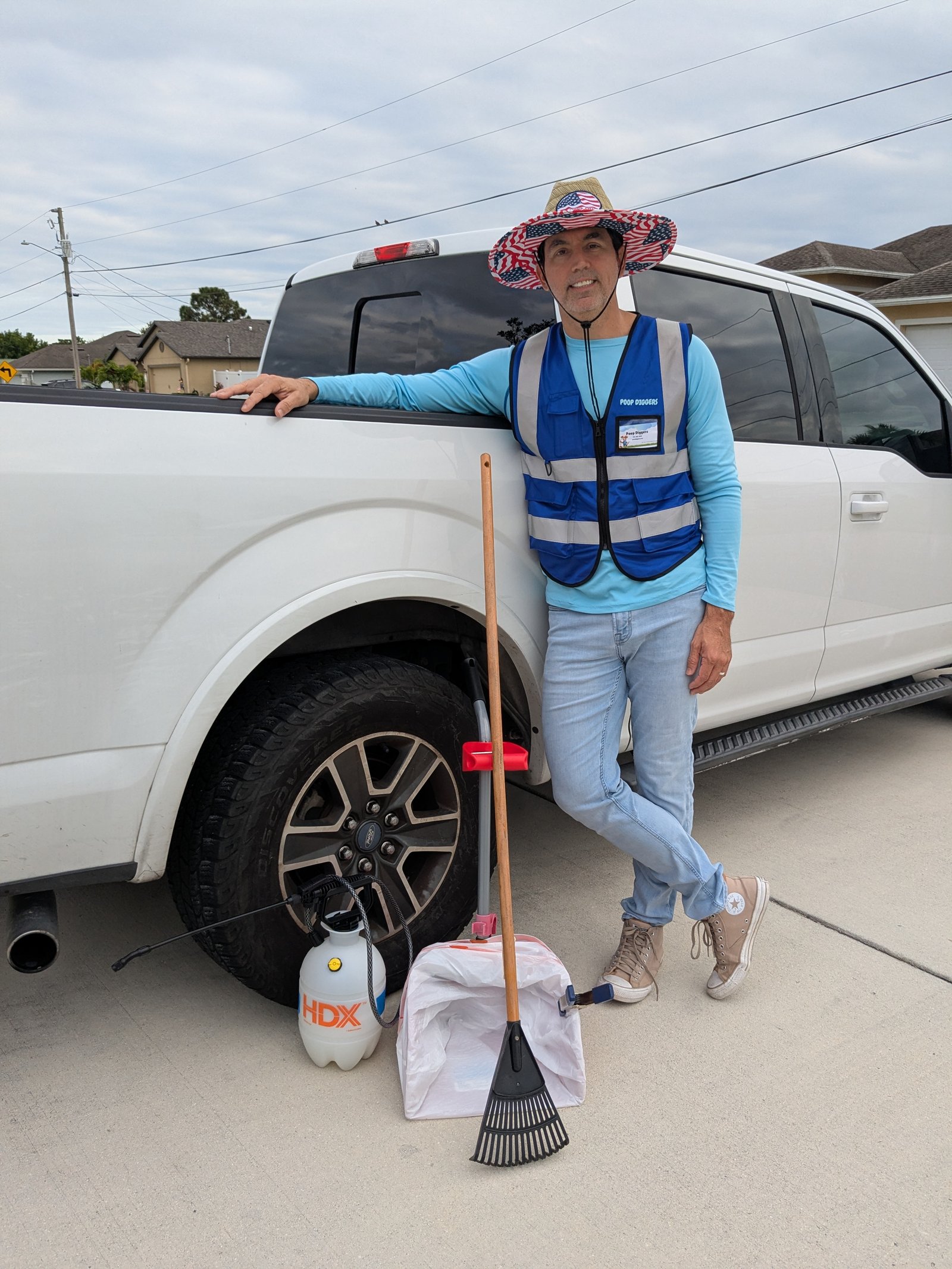 Poop Diggers founder with the company truck