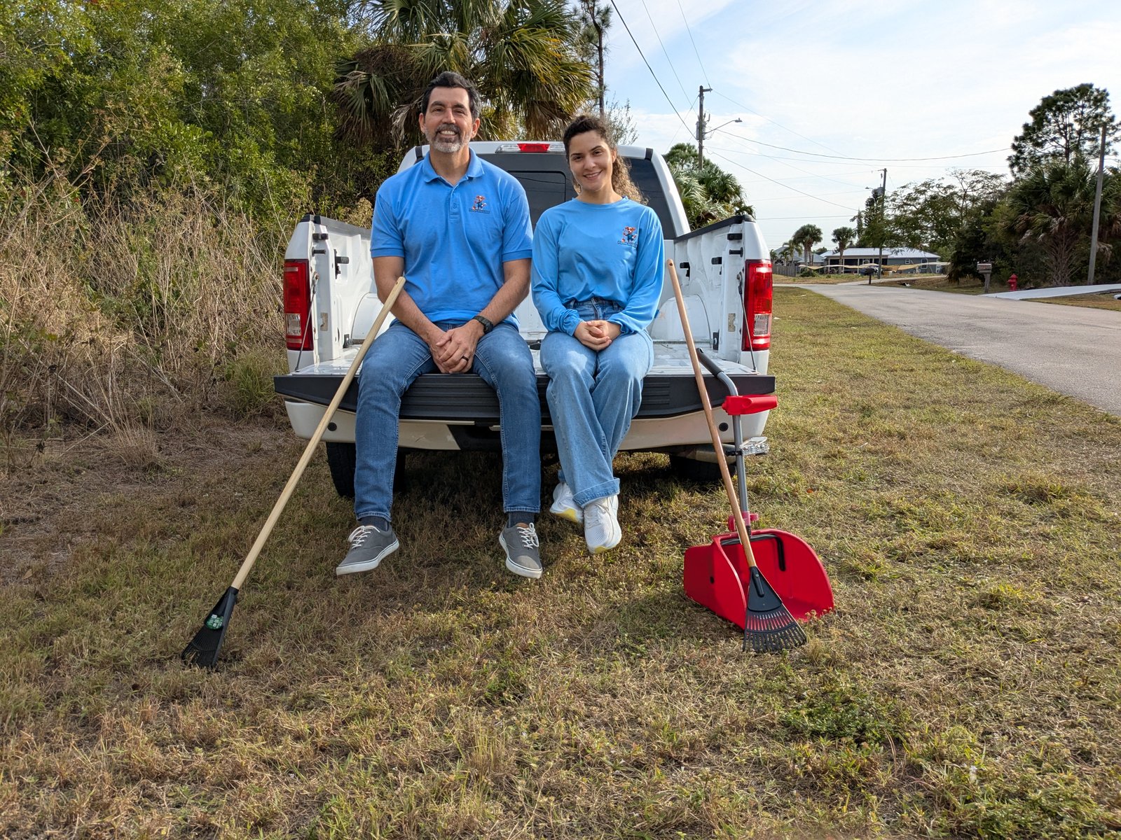The Poop Diggers team on the truck tailgate